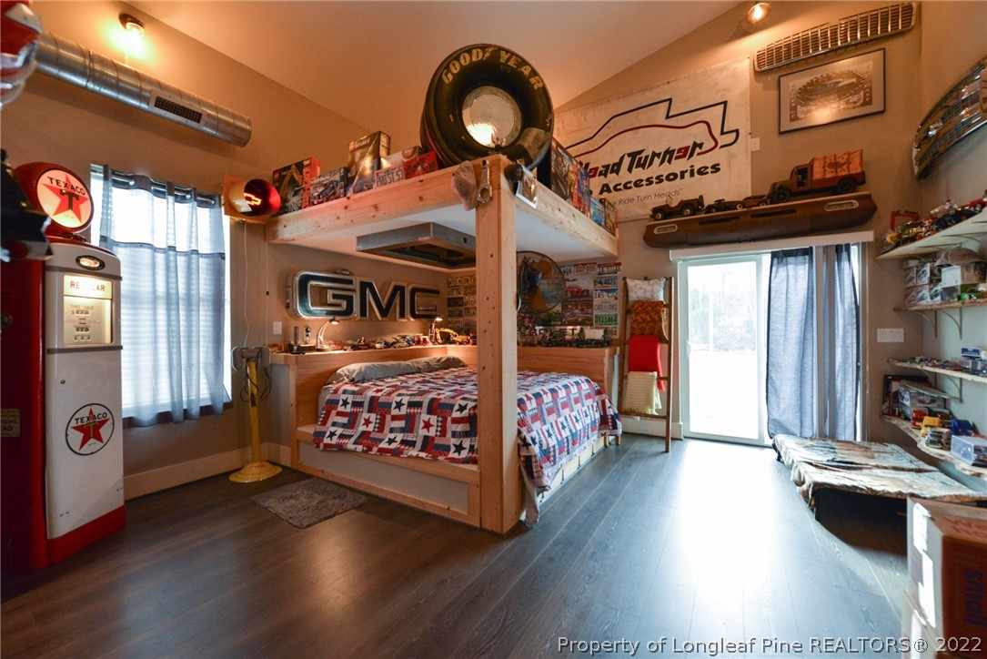 5671 Stewart Road Godwin, NC 28344 - Photo 15 of 45 a bed room with a bed and a large window