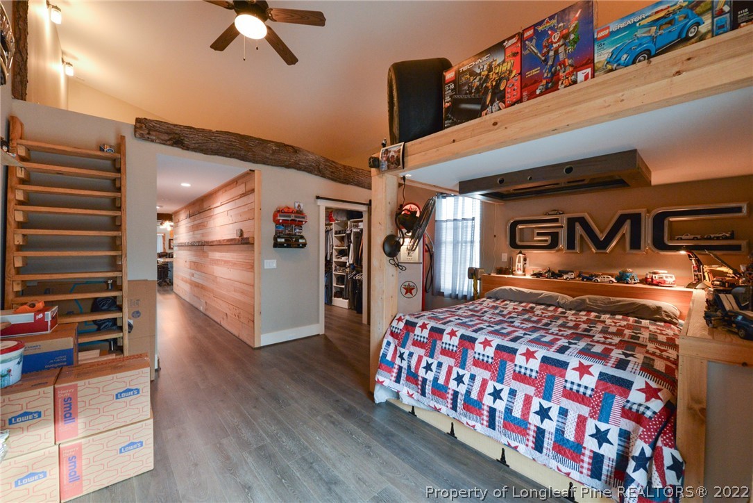 5671 Stewart Road Godwin, NC 28344 - Photo 17 of 45 a bedroom with bed and wooden floor