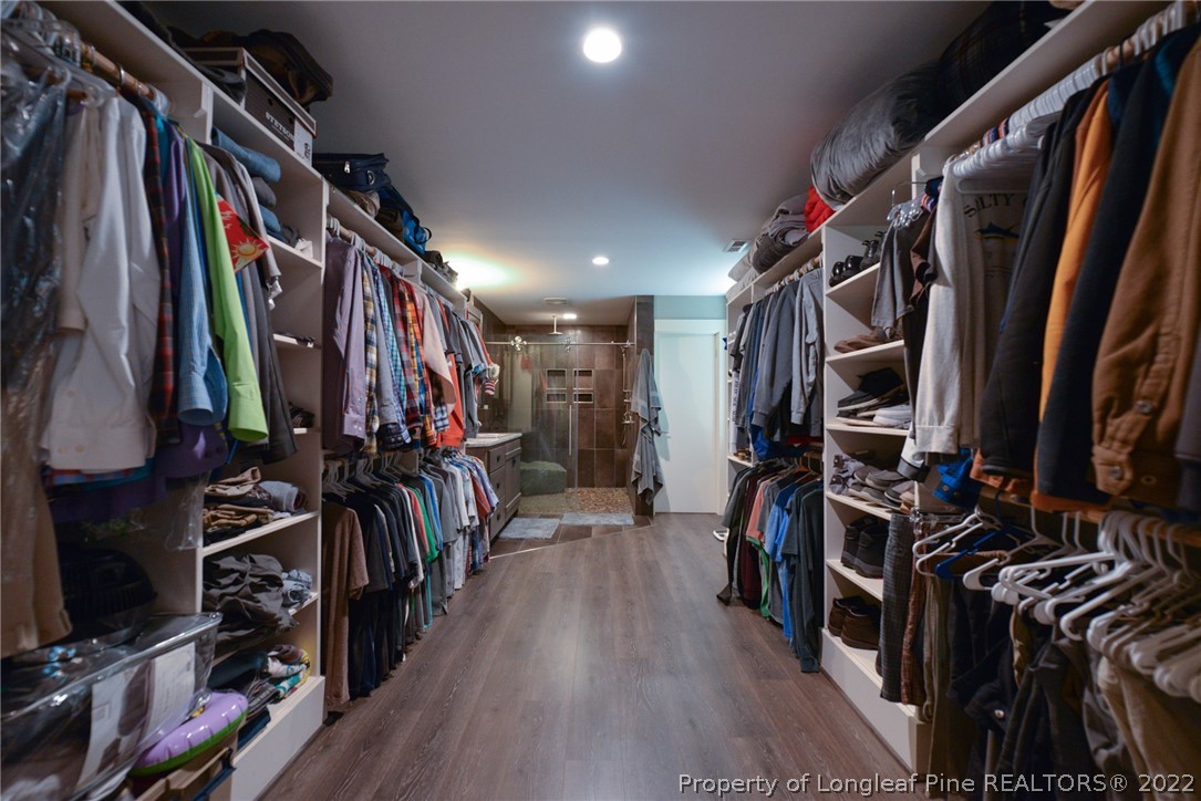 5671 Stewart Road Godwin, NC 28344 - Photo 19 of 45 a view of walk in closet with clothes