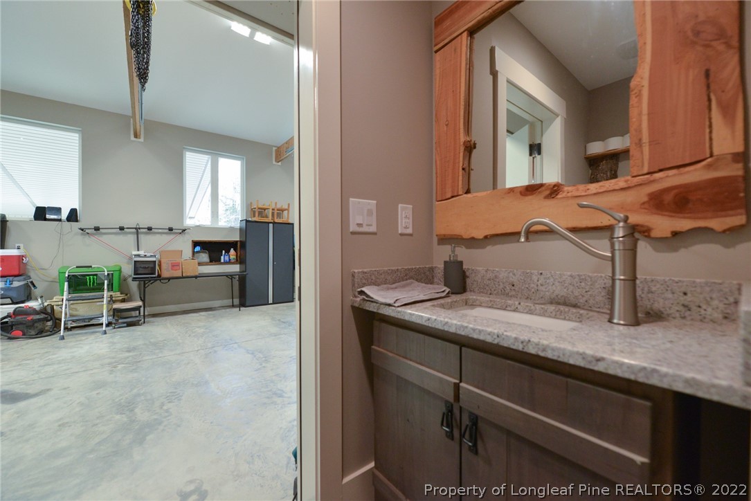 5671 Stewart Road Godwin, NC 28344 - Photo 24 of 45 a kitchen with a sink and a refrigerator