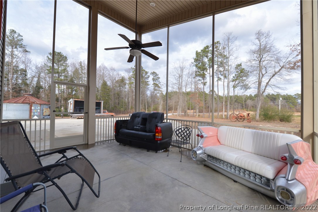 5671 Stewart Road Godwin, NC 28344 - Photo 29 of 45 a balcony with hardwood table and chairs