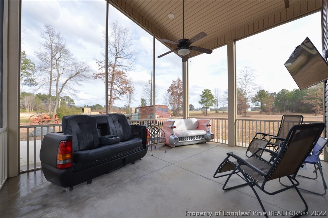 5671 Stewart Road Godwin, NC 28344 - Photo 30 of 45 a living room with couch tv and outdoor view