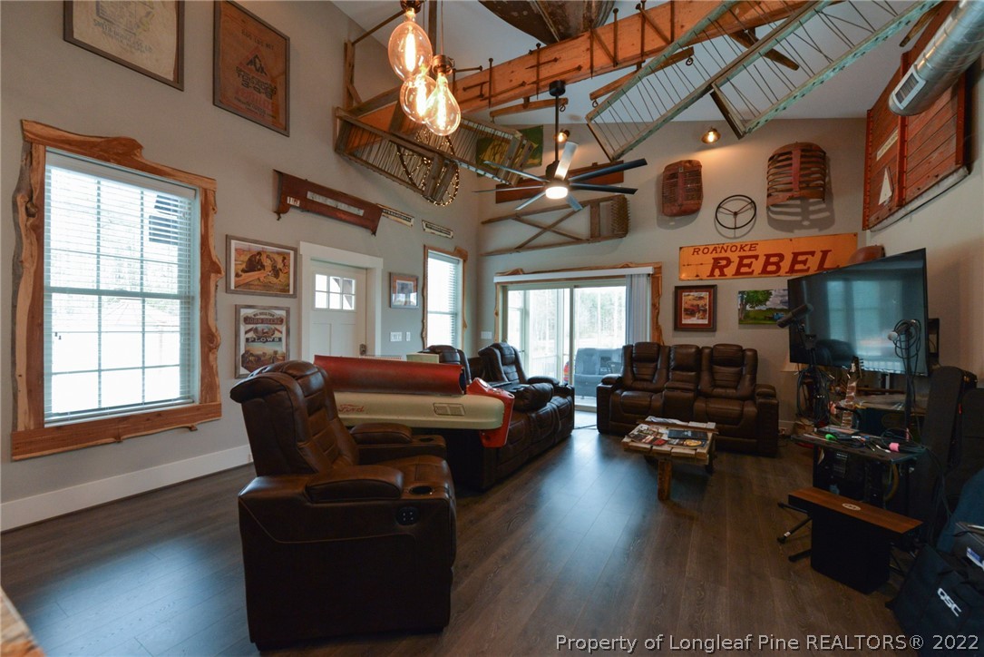 5671 Stewart Road Godwin, NC 28344 - Photo 3 of 45 a living room with furniture a flat screen tv and kitchen view