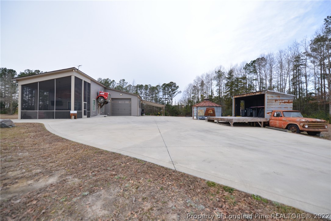 5671 Stewart Road Godwin, NC 28344 - Photo 35 of 45 a view of the house with a road