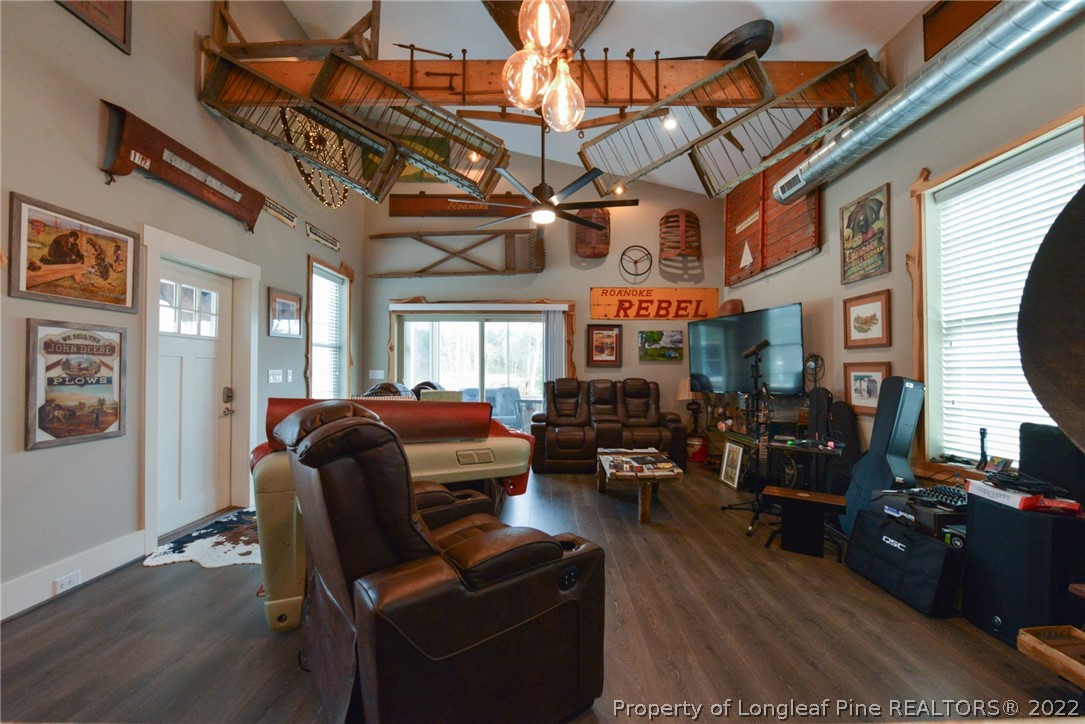 5671 Stewart Road Godwin, NC 28344 - Photo 4 of 45 a living room with furniture a fireplace and a flat screen tv