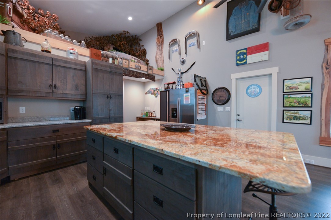 5671 Stewart Road Godwin, NC 28344 - Photo 10 of 45 a kitchen with kitchen island a stove and a wooden floors