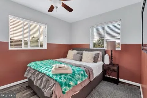 a bedroom with a bed chandelier and a window