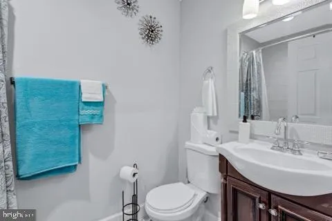 a bathroom with a sink a toilet and mirror