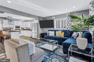 a living room with fireplace furniture and a flat screen tv