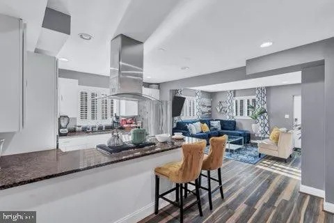 a dining room with furniture and wooden floor