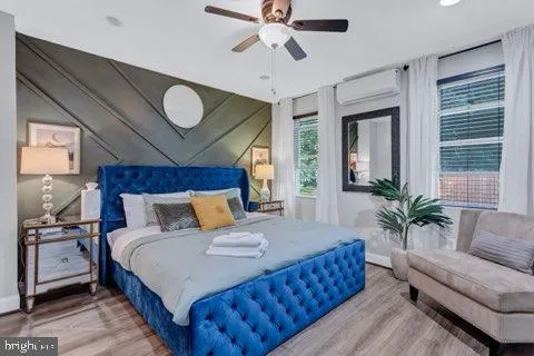 a bedroom with a large bed and a chandelier