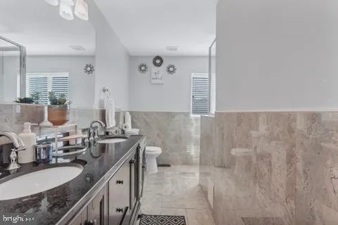 a bathroom with double sink and a mirror