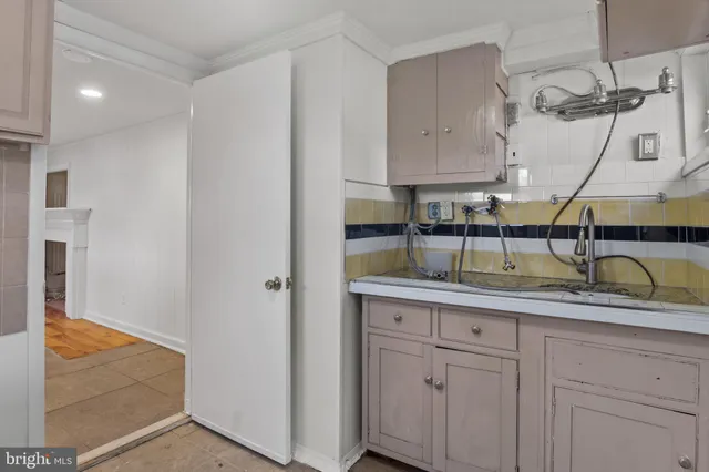 a en suite bathroom with a granite countertop sink and a mirror