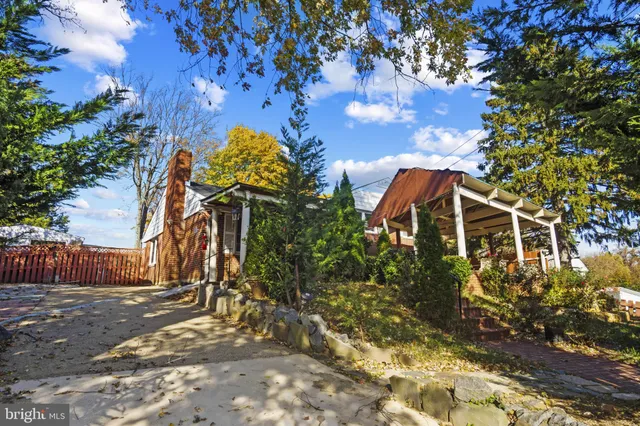 a view of a house with a tree and plants