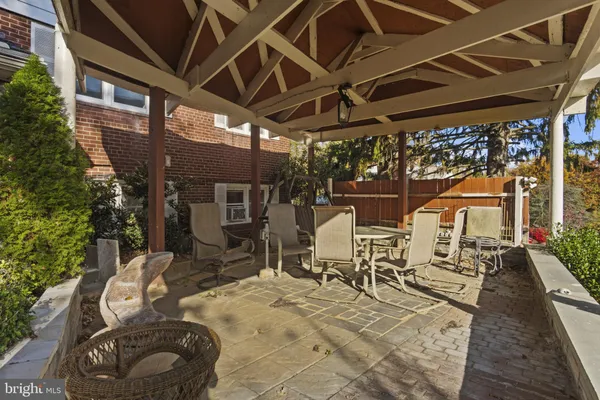 a view of a patio with table and chairs under an umbrella