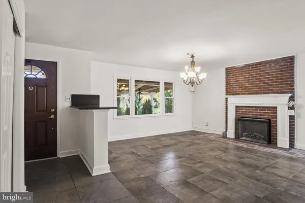 a view of an empty room with glass door and a window