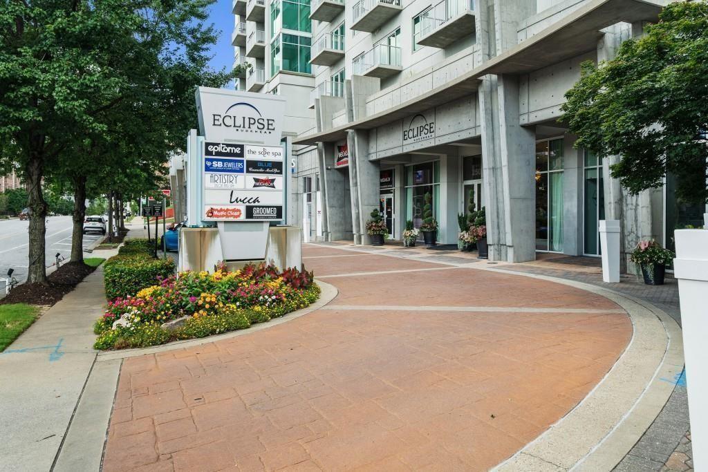 250 Pharr Road Northeast, Unit 1304 Atlanta, GA 30305 - Photo 34 of 35 a front view of a building with garden and trees