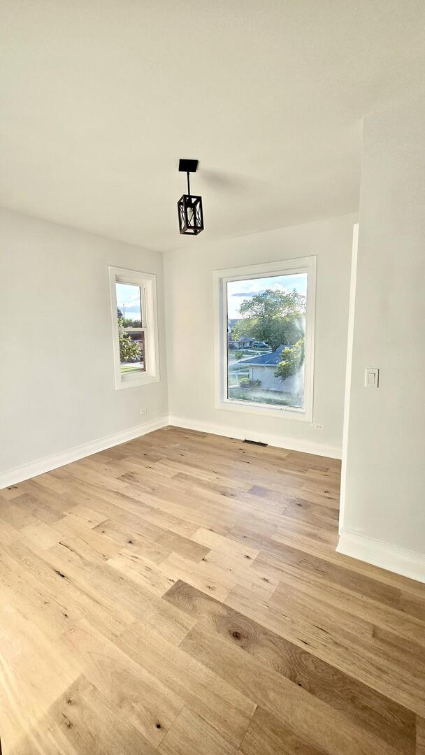 5936 West Maple Avenue Berkeley, IL 60163 - Photo 17 of 25 wooden floor in an empty room