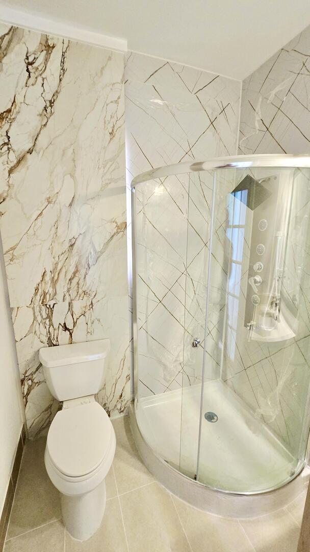 5936 West Maple Avenue Berkeley, IL 60163 - Photo 20 of 25 a bathroom with a toilet and a shower