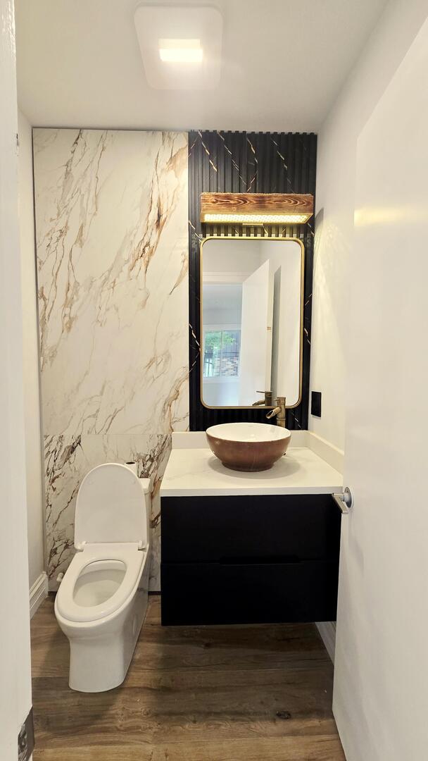 5936 West Maple Avenue Berkeley, IL 60163 - Photo 8 of 25 a bathroom with a sink a toilet and a shower