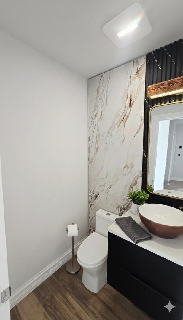 5936 West Maple Avenue Berkeley, IL 60163 - Photo 9 of 25 a bathroom with a toilet a sink and a mirror