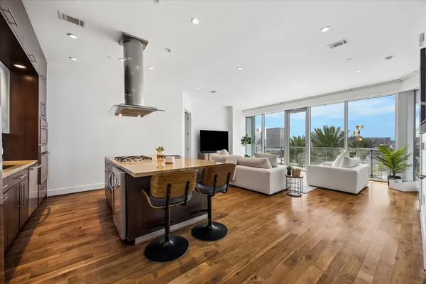 a living room with furniture flat screen tv and a large window