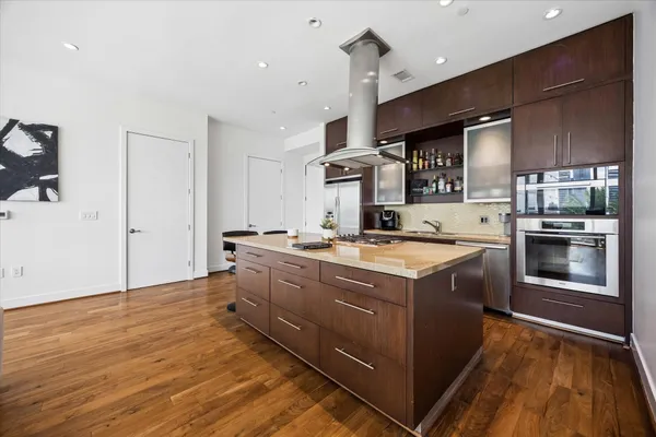 a kitchen with stainless steel appliances granite countertop a stove and a refrigerator