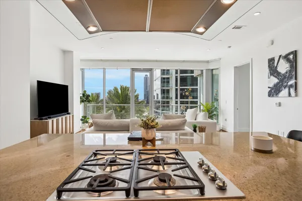a living room with furniture a flat screen tv and a large window