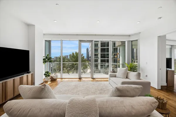 a living room with furniture tv and a large window