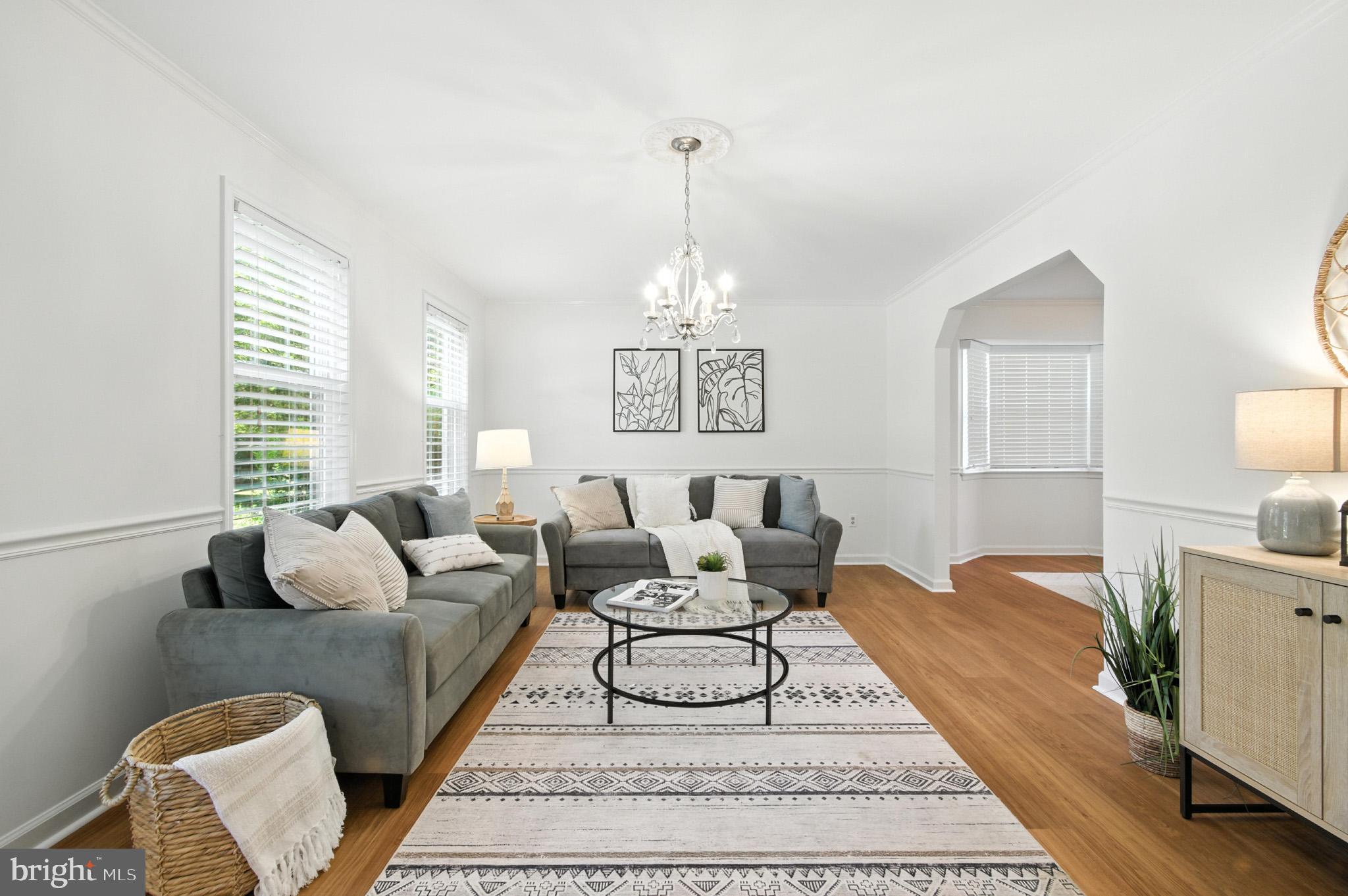 6030 Watch Chain Way Columbia, MD 21044 - Photo 15 of 90 a living room with furniture a large window and a chandelier