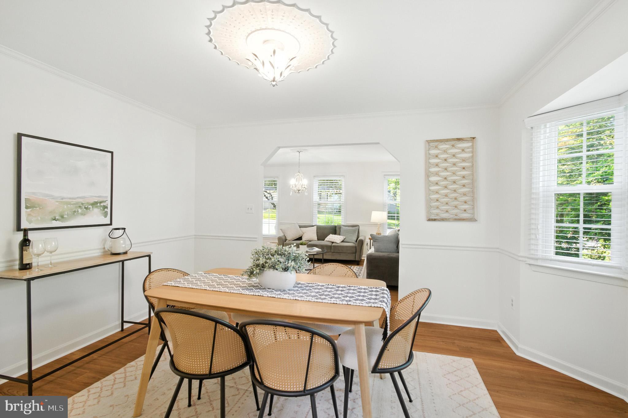 6030 Watch Chain Way Columbia, MD 21044 - Photo 23 of 90 a dining room with furniture a rug and a chandelier