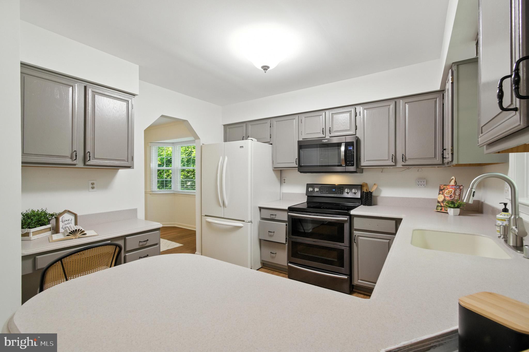 6030 Watch Chain Way Columbia, MD 21044 - Photo 26 of 90 a kitchen with stainless steel appliances granite countertop a refrigerator stove microwave and sink