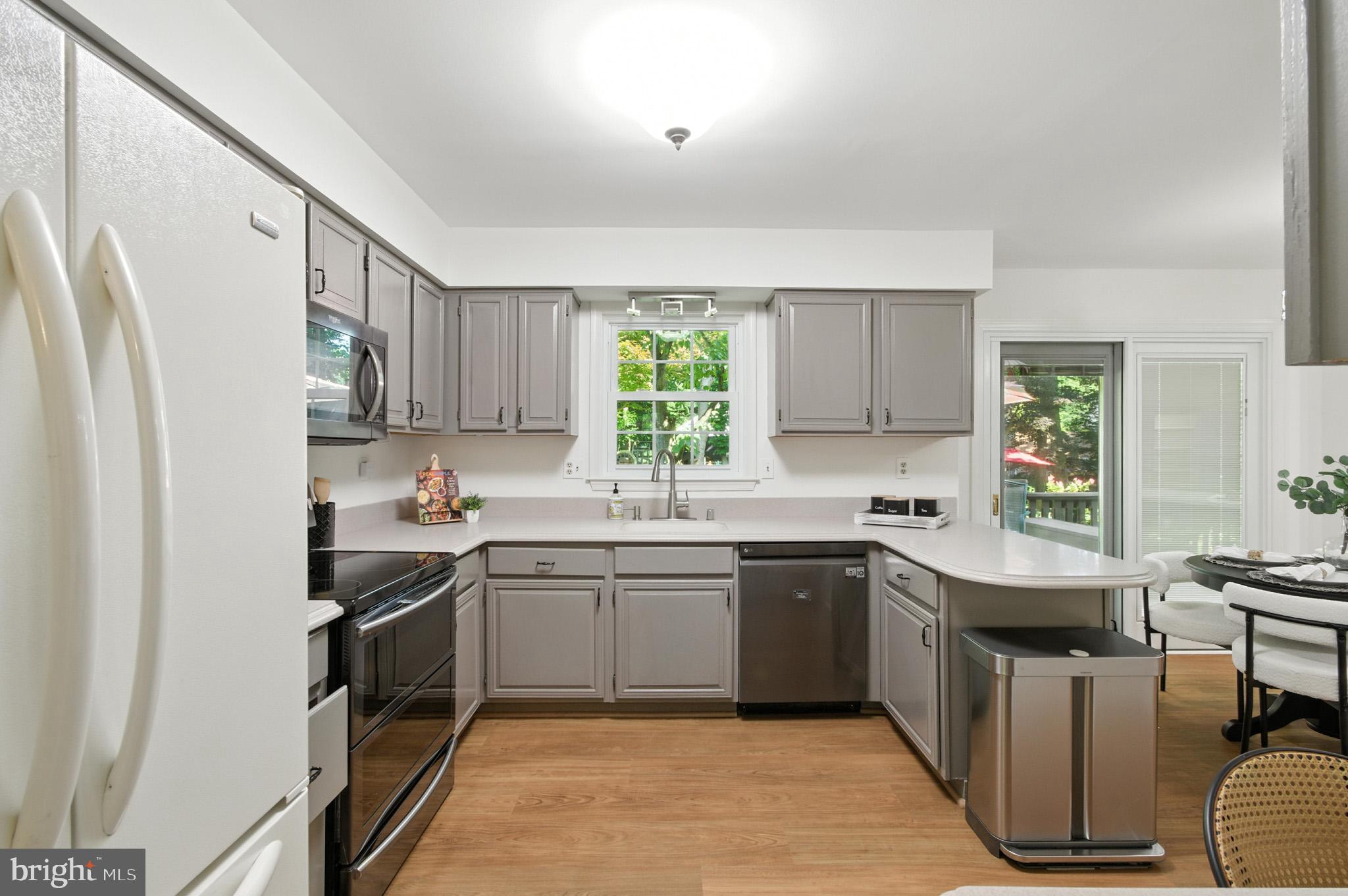 6030 Watch Chain Way Columbia, MD 21044 - Photo 31 of 90 a kitchen with stainless steel appliances granite countertop a sink stove refrigerator and cabinets
