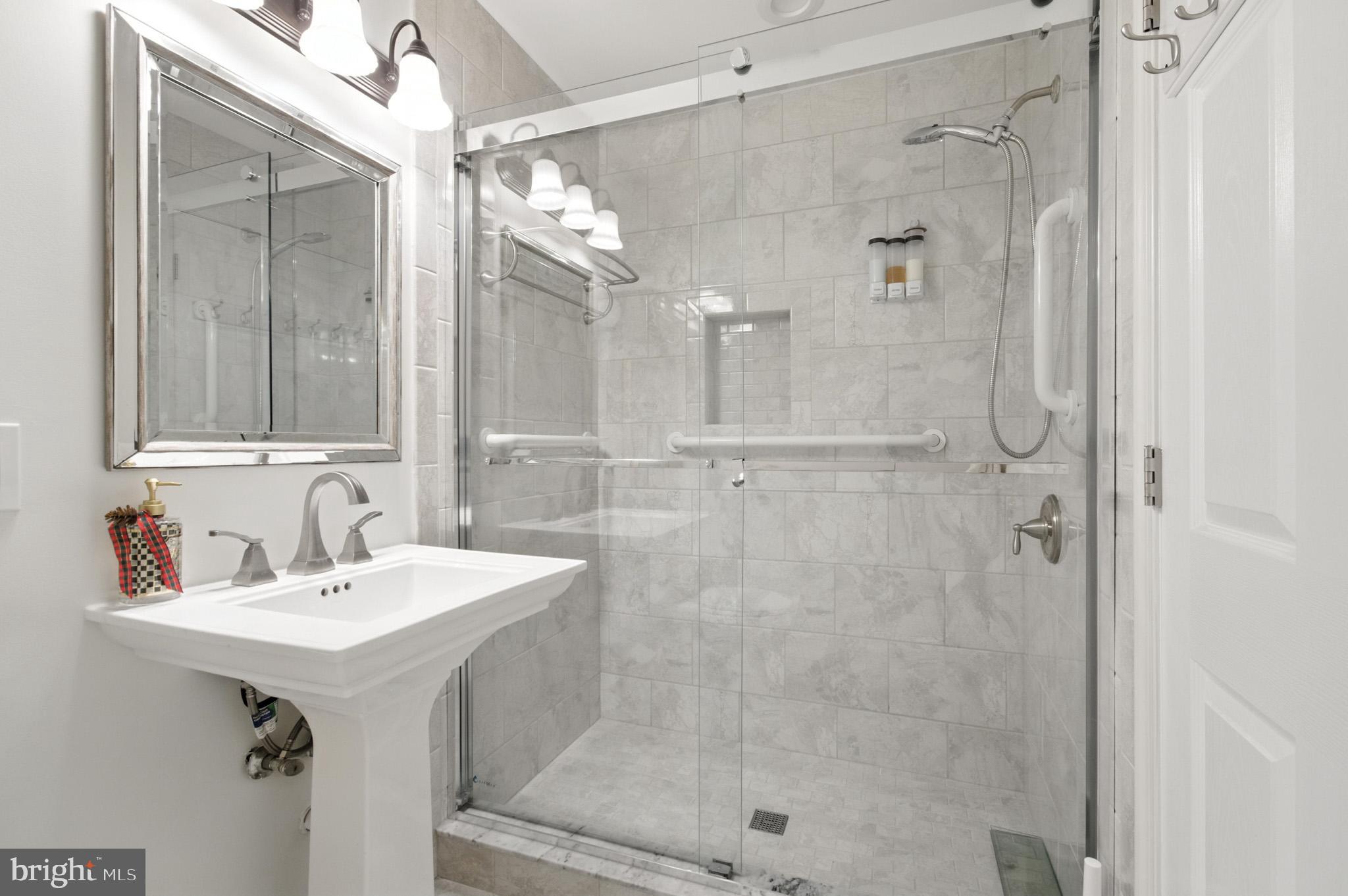 6030 Watch Chain Way Columbia, MD 21044 - Photo 41 of 90 a bathroom with a shower sink and mirror