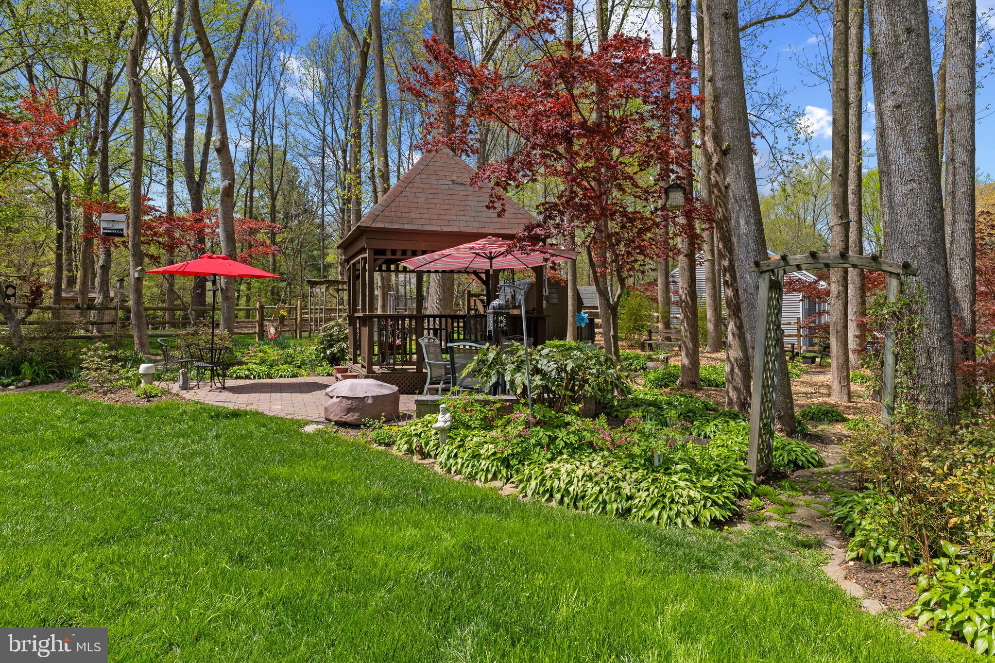 6030 Watch Chain Way Columbia, MD 21044 - Photo 70 of 90 a view of a patio with table and chairs under an umbrella