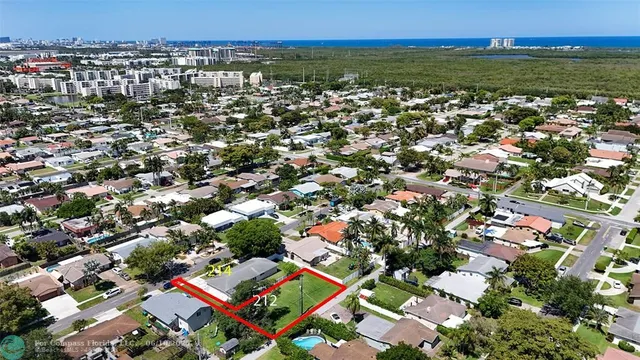 an aerial view of residential houses with city view