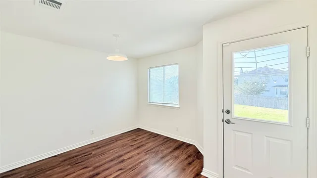a view of a room with wooden floor and a sink