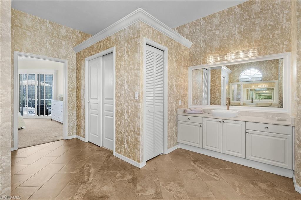 258 Monterey Drive Naples, FL 34119 - Photo 12 of 36 a view of a bathroom with mirror and shower