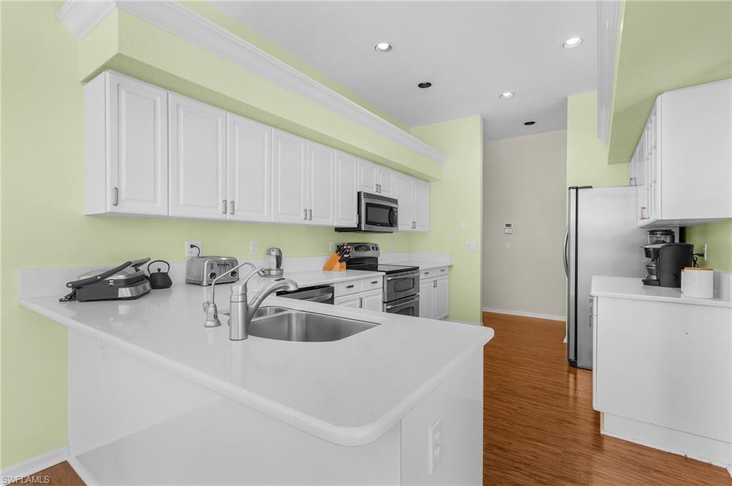 258 Monterey Drive Naples, FL 34119 - Photo 17 of 36 a kitchen with a sink appliances and cabinets