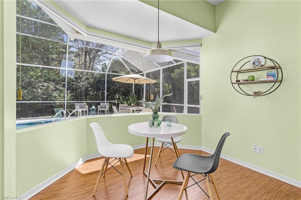 258 Monterey Drive Naples, FL 34119 - Photo 18 of 36 a view of a dining room with furniture window and wooden floor