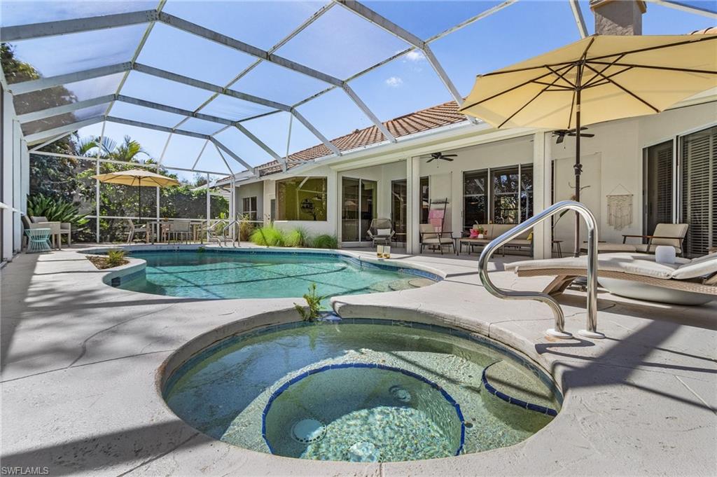 258 Monterey Drive Naples, FL 34119 - Photo 22 of 36 a swimming pool with outdoor seating and yard