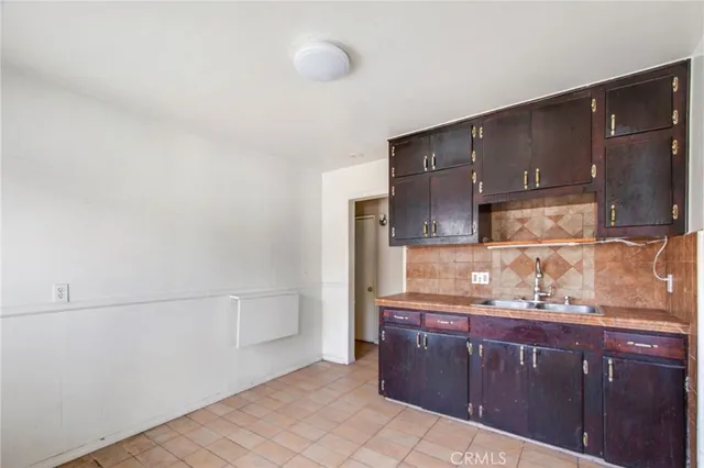 a kitchen with stainless steel appliances granite countertop a refrigerator and a stove