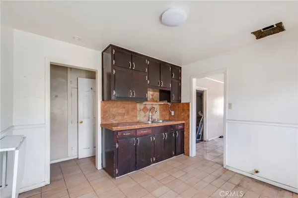 a kitchen with stainless steel appliances granite countertop a refrigerator and a stove