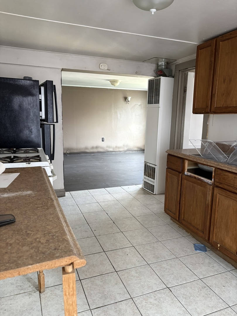 2014 West 52nd Street Chicago, IL 60609 - Photo 15 of 35 a kitchen with kitchen island granite countertop a refrigerator oven a sink and dishwasher