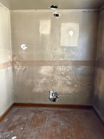 a bathroom with a bathtub and a window