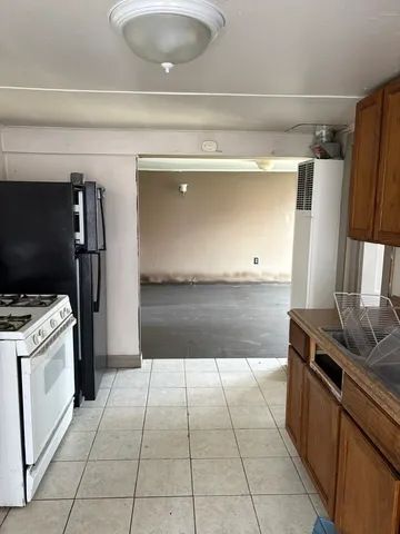 an empty room with cabinet and windows