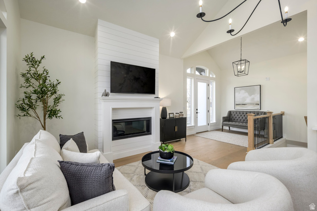 250 South Main Street, Unit 25 Alpine, UT 84004 - Photo 8 of 31 Living room with wood finished floors, vaulted ceiling, a large fireplace, and a chandelier