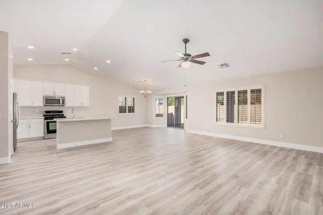 a view of kitchen with stainless steel appliances kitchen island a sink and wooden floor