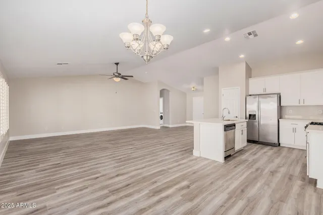a view of a kitchen with a sink and refrigerator
