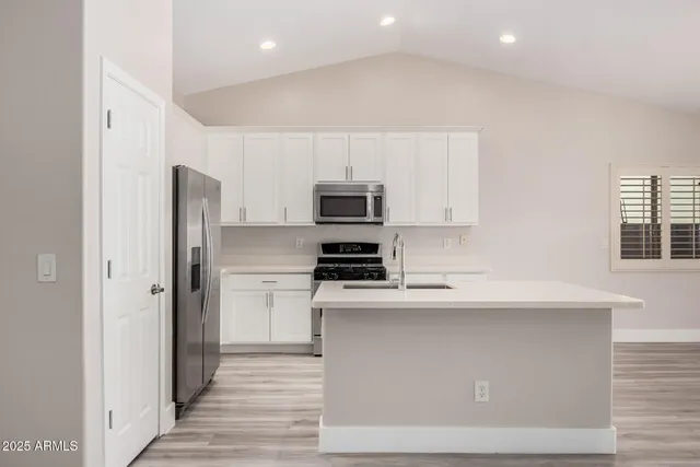 a kitchen with a refrigerator stove and microwave